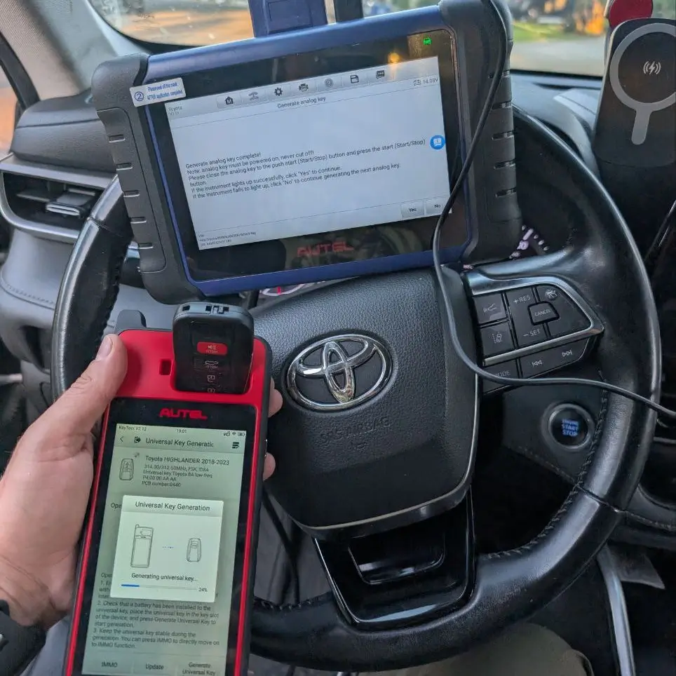 Autel device generating a universal smart key for a Toyota Highlander 2018–2023; on-site key fob programming inside the vehicle.
