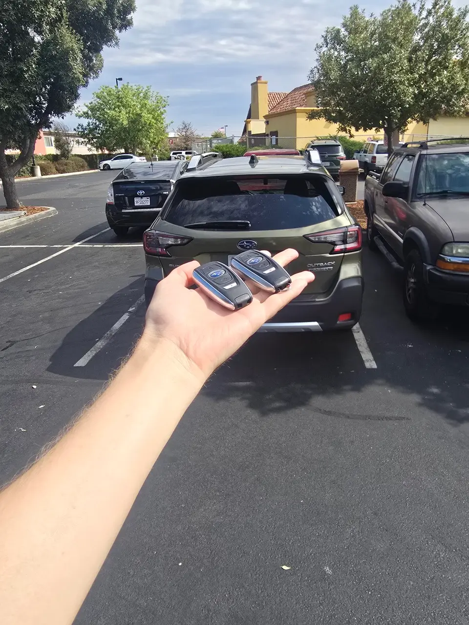 Locksmith providing Subaru key replacement and programming a new smart key fob.